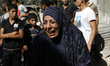 A Palestinian woman grieve on their home, which was destroyed by Israeli warplanes in Khan...
