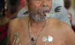 Tamil Hindu devotee with body piercings and facial skewers as an act of penance during the...