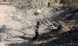Palestinian policemen loyal to Hamas inspect the scene of an Israeli air strike in the nor...