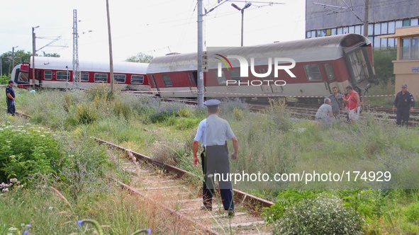 Bulgarian police officers and investigators attend near train crash near the village of Kalojanovec east of the Bulgarian capital Sofia, Sat...