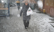 People are seen in the streets of Bydgoszcz, Poland during heavy snowfall on 24 February,...