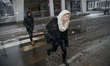 People are seen in the streets of Bydgoszcz, Poland during heavy snowfall on 24 February,...