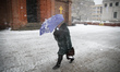 People are seen in the streets of Bydgoszcz, Poland during heavy snowfall on 24 February,...