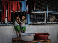 Palestinians, who fled their family homes in the northern border town of Beit Lahiya, stay at a United Nations-run school in Gaza City July...
