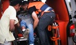 Palestinians carry a wounded protester after Israeli troops fired tear gas canisters follo...