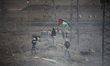 A Palestinian Protester holds Palestine flag during clashes following a protest at the Nah...