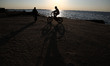  Palestinian boys rides  bicycle during sunset in Gaza City, on March 5, 2017. 