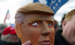 Wearing a plastic Trump mask found at a party store, Alex Carlin of Willow grove, PA, atte...