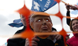 Wearing a plastic Trump mask found at a party store, Alex Carlin of Willow grove, PA, atte...