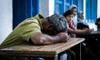 A man sleeping exhausted on a table at Jabalya, Gaza on July 18th, 2014. The former school...