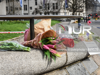 Floral tributes with a message reading 'We are not afraid, our hearts are with you' are seen near a police cordon in Westminster in London,...