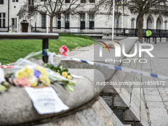 Floral tributes with a message reading 'We are not afraid, our hearts are with you' are seen near a police cordon in Westminster in London,...