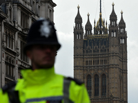 A police officer near Elizabeth Tower (Big Ben) at the Houses of Parliament in London, on March 23, 2017. Police continue investigations aft...