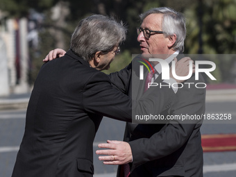 Italian Prime Minister Paolo Gentiloni, left, greets European Commission President Jean-Claude Juncker during arrivals for an EU summit at t...