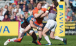 Joel Hodgson of Newcastle Falcons is tackled by Harlequins Nick Evans during Aviva Premier...
