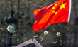 People hold up roses as they gather at Place de la Republique in Paris, France on April 2,...