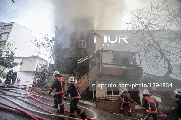 Firefighters works to extinguish flames during a fire in a building in Kurtulus, Istanbul, on April 12, 2017. Fire was for an electrical fau...