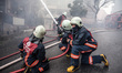 Firefighters works to extinguish flames during a fire in a building in Kurtulus, Istanbul,...