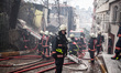 Firefighters works to extinguish flames during a fire in a building in Kurtulus, Istanbul,...