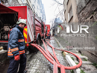 Firefighters works to extinguish flames during a fire in a building in Kurtulus, Istanbul, on April 12, 2017. Fire was for an electrical fau...
