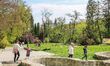 People enjoy hot and sunny weather walking in park near the Barlangfurdo cave bath complex...
