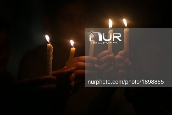 Palestinian boys hold candles during a protest against the blockade on Gaza, in Gaza City April 14, 2017. 
 