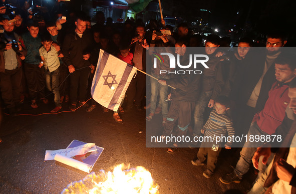 Palestinian youths burn  burn an Israeli flag  during a protest against the Israeli blockade of the Gaza Strip on April 14, 2017, in in Gaza...
