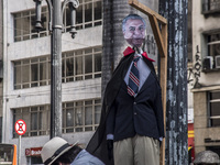 A puppet of Brazilian President Michel Temeris hanged up by a group of protesters at in Sao Paulo, Brazil on April 15, 2017. (