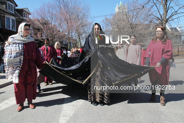 A participant playing the role of Virgin Mary dressed in a black shroud after the Crucifixion of Jesus Christ during the Good Friday process...