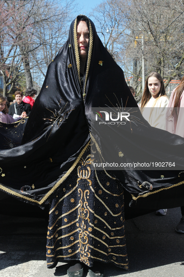 A participant playing the role of Virgin Mary dressed in a black shroud after the Crucifixion of Jesus Christ during the Good Friday process...