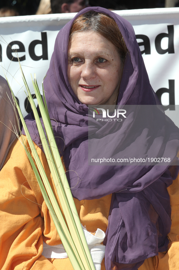 Woman carrying a palm leaf during the Good Friday procession in Little Italy in Toronto, Ontario, Canada, on April 14, 2017. The Saint Franc...