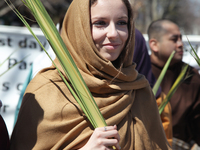 Woman carrying a palm leaf during the Good Friday procession in Little Italy in Toronto, Ontario, Canada, on April 14, 2017. The Saint Franc...