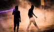 Bahrain , Abu Saiba - (R) protester walking in tear gas clouds while other protester using...