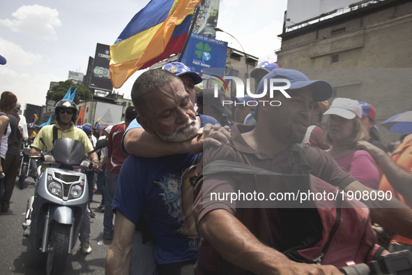 An injured person during clashes with police during a march against Venezuelan President Nicolas Maduro, in Caracas on April 19, 2017. Venez...