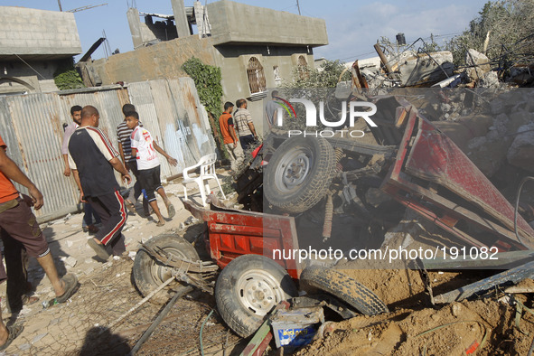 Rescue workers remove the body of a member of al-Najar family, after digging it up from under the rubble of their home following an Israeli...