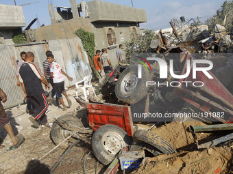 Rescue workers remove the body of a member of al-Najar family, after digging it up from under the rubble of their home following an Israeli...