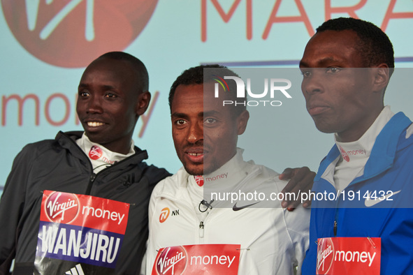Second placed Ethiopia's Kenenisa Bekele (C), winner Kenya's Daniel Wanjiru (L) and third placed Kenya's Bedan Karoki (R) pose on the podium...