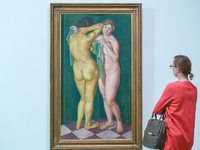 A lady looks at Zbigniew Pronaszko's oil canvas 'Two Nudes Standing' - a part of 'Art in Art' new exhibition that features a wide range of w...