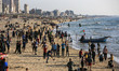 Palestinians enjoy warm weather at the beach of Gaza shore in Gaza City, Gaza on April 28,...