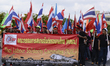 Thai workers hold a placard as they rally to mark the international worker's day in on 1st...