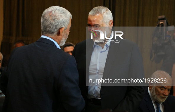 Hamas leader Ismail Haniyeh (R) kisses Hamas Gaza Chief Yehya Al-Sinwar during a ceremony announcing a new policy document, in Gaza City May...