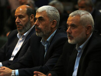 Yahya Sinwar (C-L), the new leader of the Hamas Islamist movement in the Gaza Strip and senior political leader Ismail Haniyeh (C) attend a...
