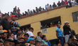 People watching the street football match from the building in Lima, Peru. May 1, 2017. Fo...