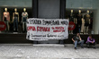 Entrance of an H&M store with banner against work on Sundays, in central Athens, Greece on...