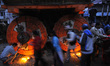 Nepalese devotees offering ritual prayer on wheel of chariot Rato Machindranath at Lagankh...