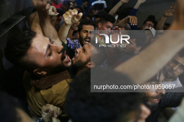 Palestinian mourners shout slogans as the body of fisherman Mohammed Majed Bakr, 25, arrives at a morgue in Gaza City, on May 15, 2017. An I...