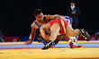 Katea Tebitara for Solomon Islands competes against Qamar Abbas for Pakistan at Wrestling...