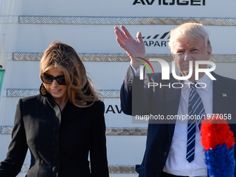 US President Donald Trump and his wife, First Lady Melania Trump, wave goodbye from Air Force One in Airport Fiumicino in  Rome on may 23, 2...