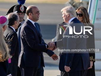 US President Donald Trump and Angelino Alfano,  shake hands at the Airport Fiumicino in  Rome on may 23, 2017 (