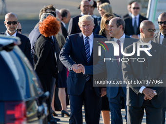 US President Donald Trump and his wife, First Lady Melania Trump, wave goodbye from Air Force One in Airport Fiumicino in  Rome on may 23, 2...